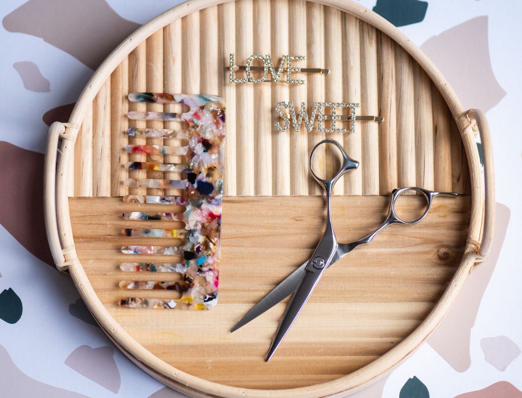 Hair tools on a wooden tray arranged neatly for hair salon mebane